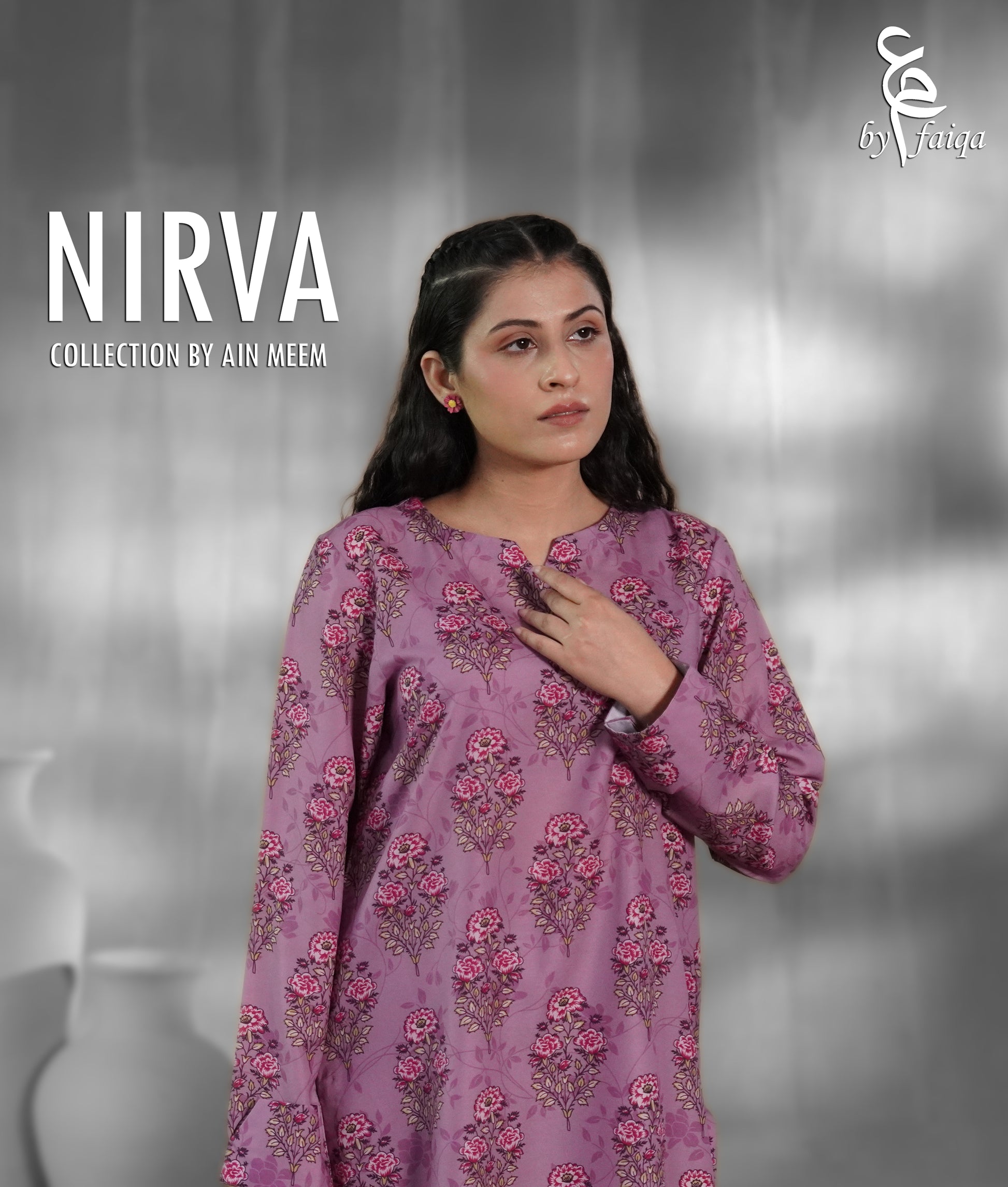 A woman modeling a lavender-purple long-sleeve kurta with pink and green floral block prints, set against a gray studio background with 'NIRVA COLLECTION BY AIN MEEM' text on the left.